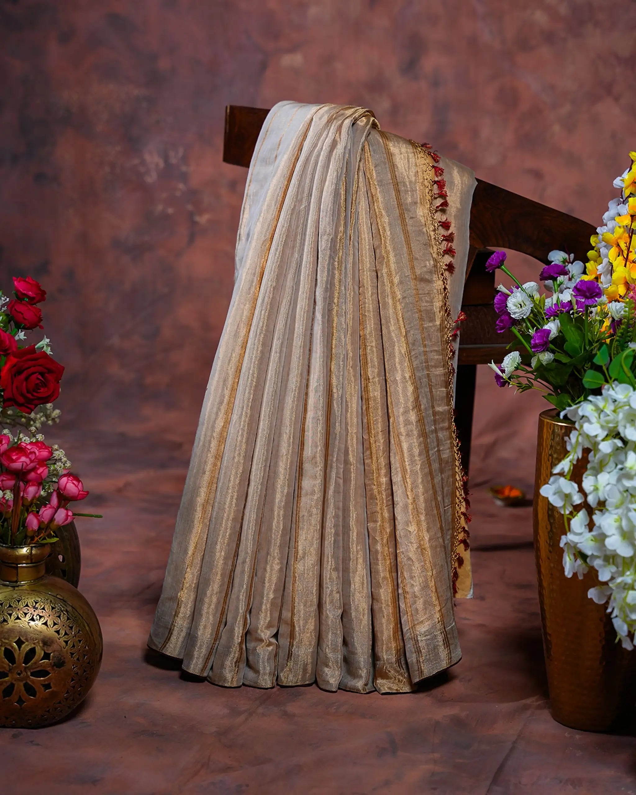 Gold Tissue Banarasi Saree with Brown Border and Red Tassels