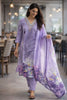 Woman in a lavender traditional outfit with a matching dupatta in a restaurant setting
